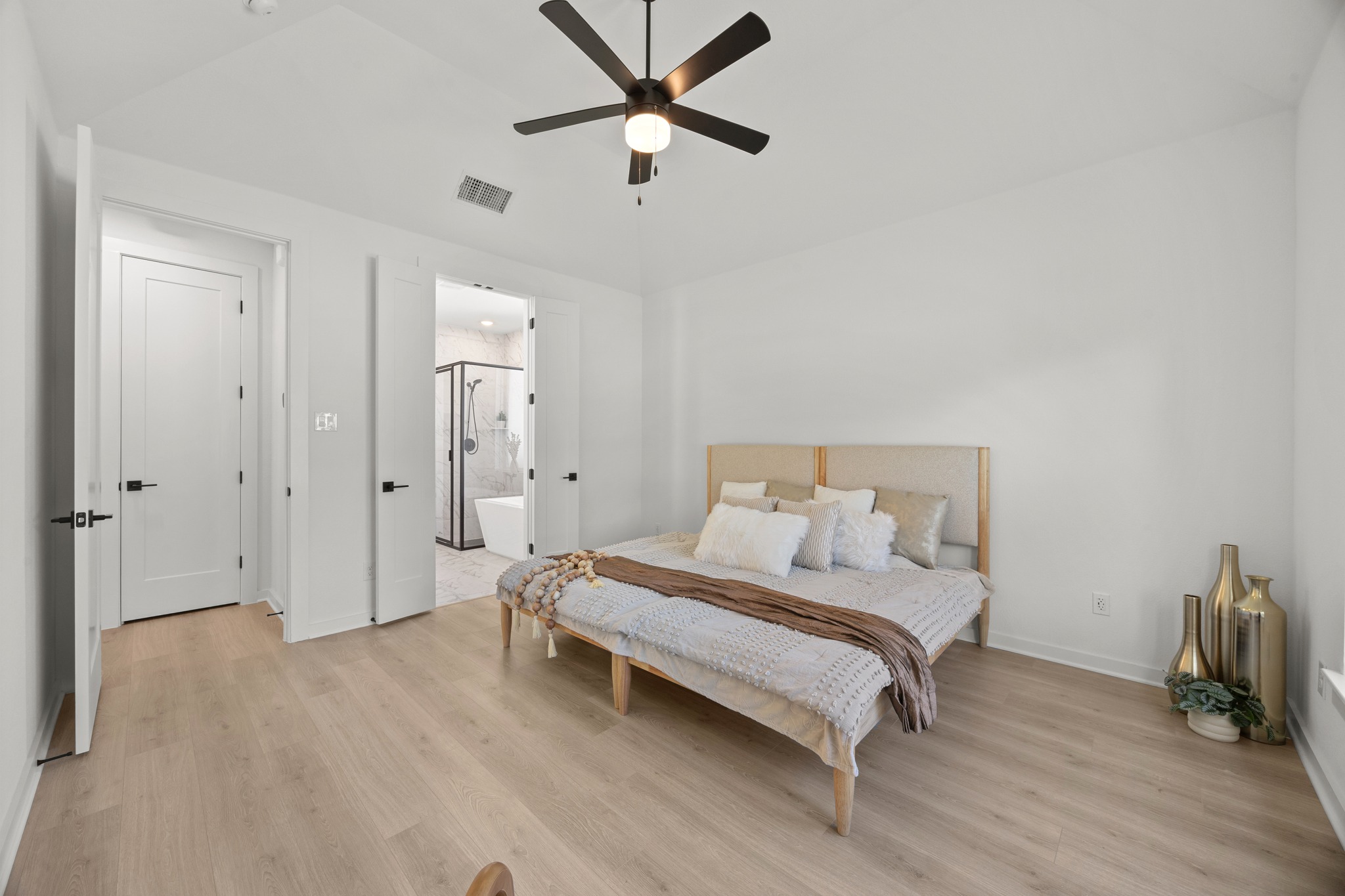 6000 Sean Paul Lane Georgetown, TX 78628 - Photo 16 of 35 Bedroom with lofted ceiling, light wood-style floors, ceiling fan, and connected bathroom