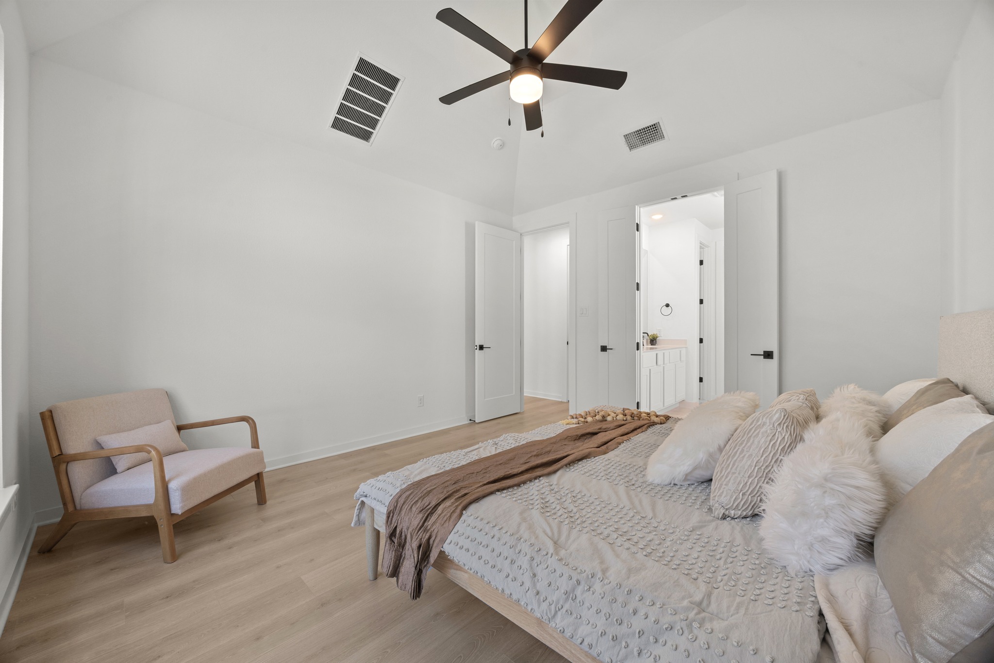 6000 Sean Paul Lane Georgetown, TX 78628 - Photo 17 of 35 Bedroom featuring light wood-style flooring, vaulted ceiling, a ceiling fan, and ensuite bathroom