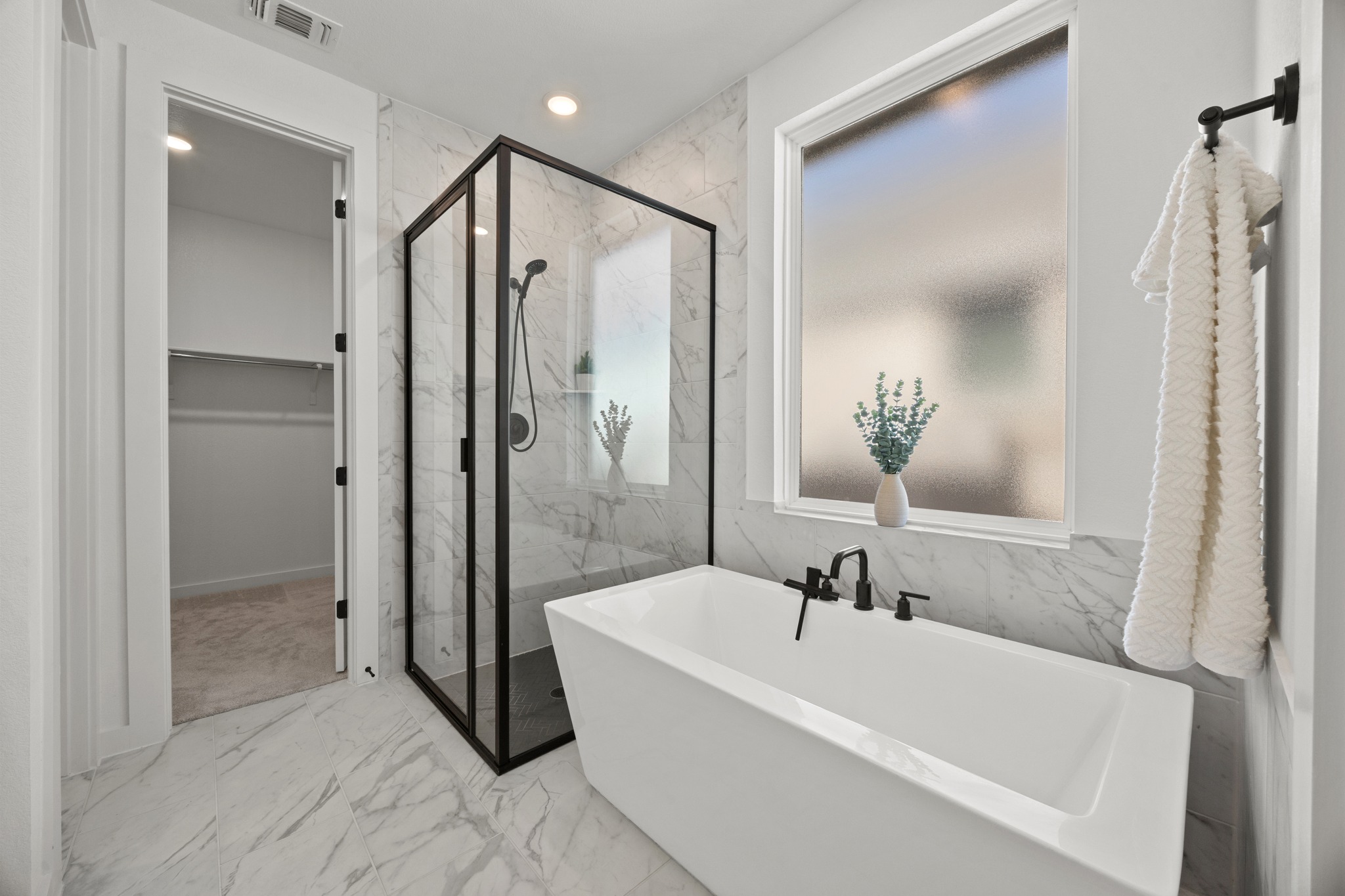 6000 Sean Paul Lane Georgetown, TX 78628 - Photo 19 of 35 Bathroom with light marble finish flooring, a marble finish shower, recessed lighting, a freestanding bath, and a walk in closet