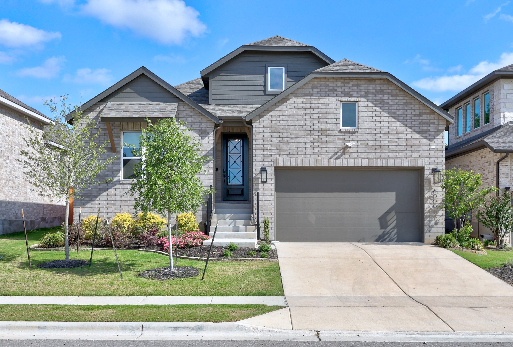 6000 Sean Paul Lane Georgetown, TX 78628 - Photo 2 of 35 View of front facade featuring a front yard, brick siding, driveway, a garage, and a shingled roof