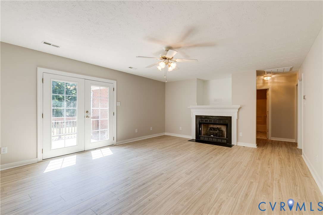 6701 Caboose Lane Sandston, VA 23150 - Photo 6 of 28 With gas fireplace and French doors leading to rea