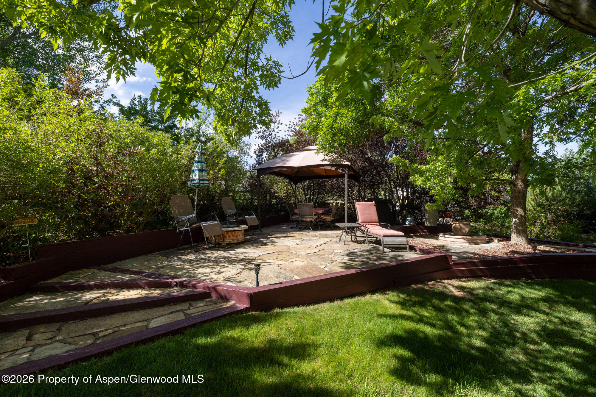1335 Firethorn Drive Rifle, CO 81650 - Photo 21 of 30 a view of a backyard with plants and patio