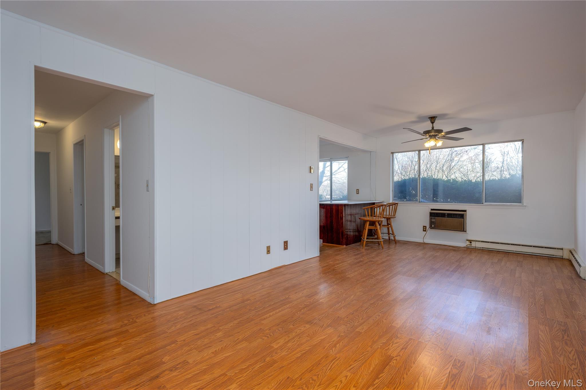 306 Old Country Road, Unit 306 Elmsford, NY 10523 - Photo 11 of 35 View of the living room looking toward the hallway to the bedrooms and bath at left and toward the dining area and the kitchen at right. Note the open concept!