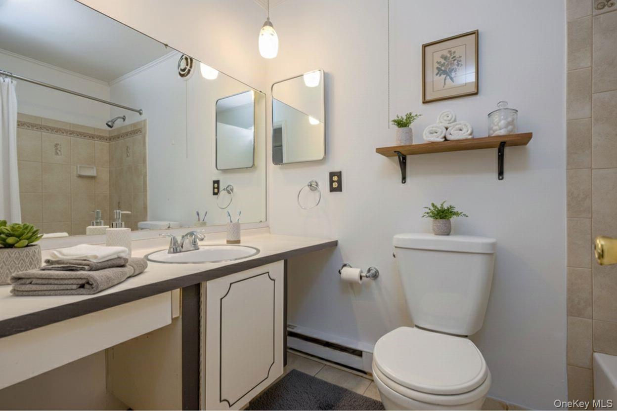 306 Old Country Road, Unit 306 Elmsford, NY 10523 - Photo 23 of 35 Virtually staged photo of the full hall bath.