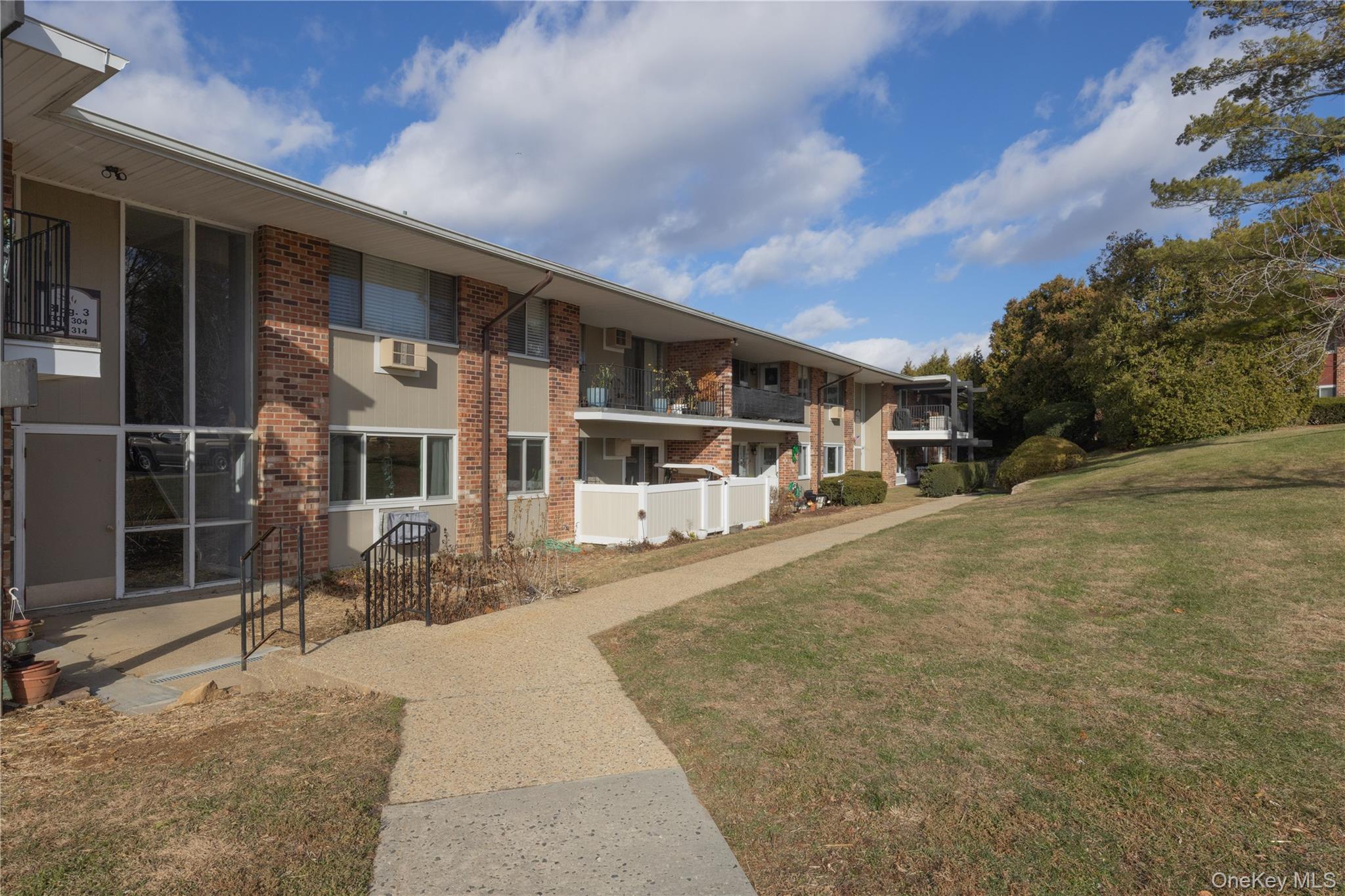 306 Old Country Road, Unit 306 Elmsford, NY 10523 - Photo 3 of 35 View of the walkway leading to the entry to unit #306.