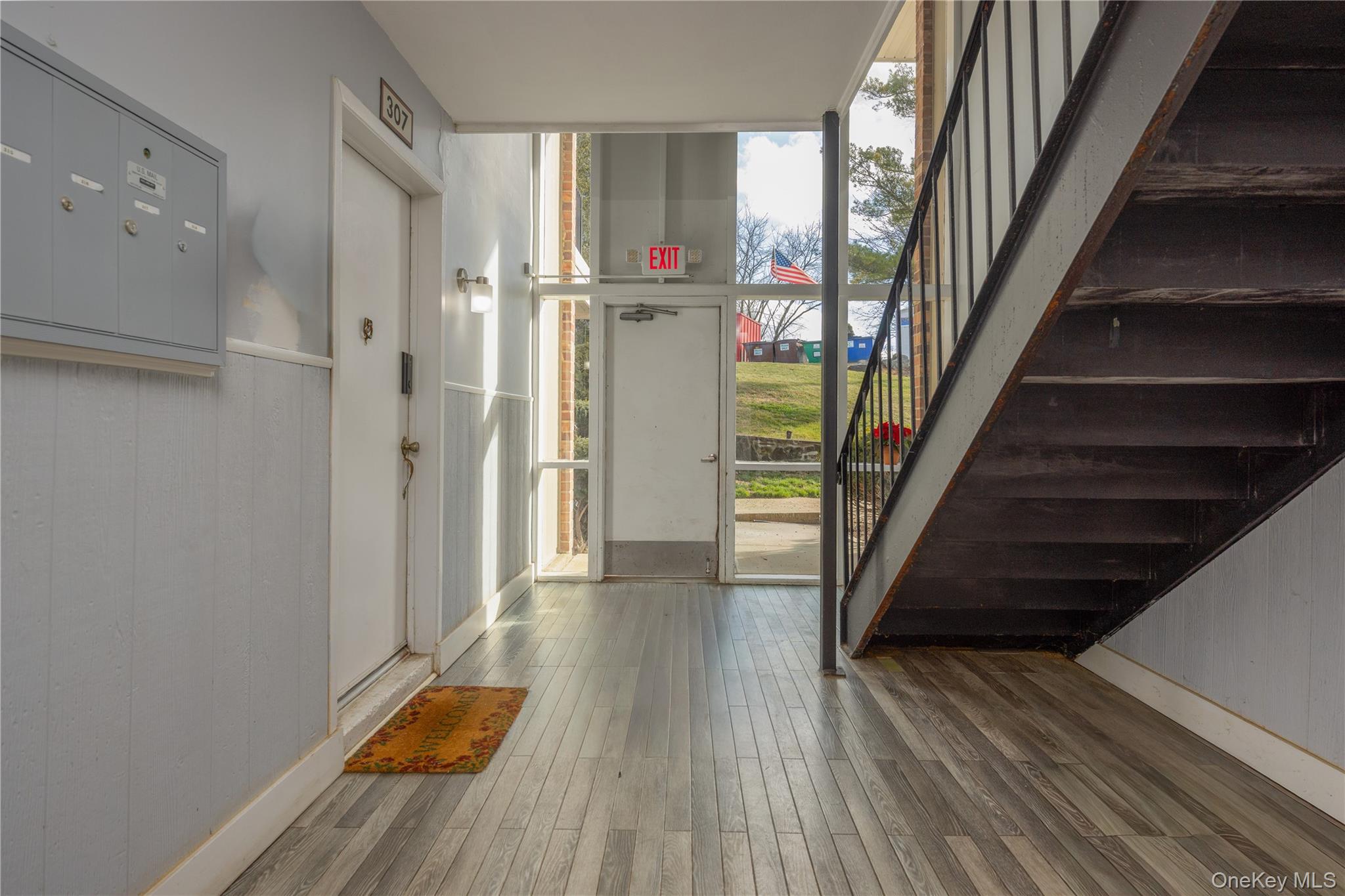 306 Old Country Road, Unit 306 Elmsford, NY 10523 - Photo 6 of 35 View of the lobby from the front door of the unit looking toward the exterior of the building.