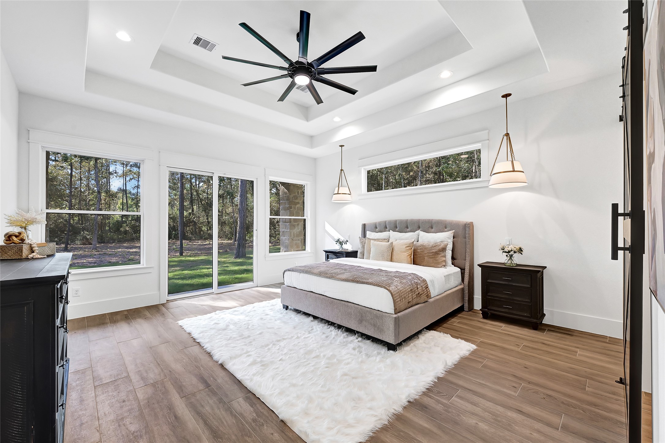 7244 Red Oak Grove Road Montgomery, TX 77316 - Photo 15 of 49 a spacious bedroom with a large bed and a chandelier fan