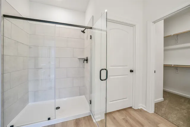 a bathroom with a glass shower door