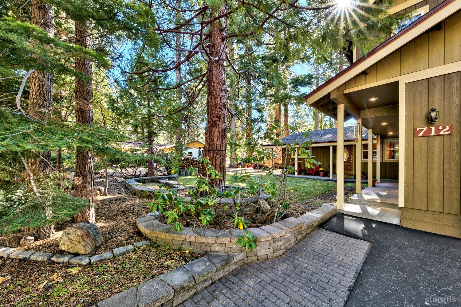 712 Sand Harbor Road South Lake Tahoe, CA 96150 - Photo 1 of 38 a view of a house with a yard and sitting area