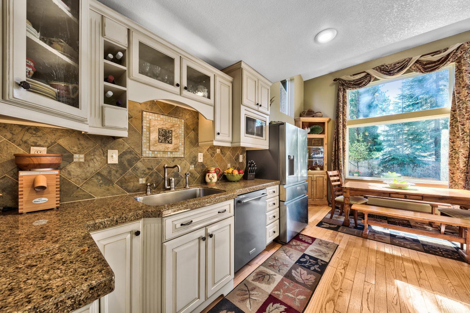 712 Sand Harbor Road South Lake Tahoe, CA 96150 - Photo 15 of 38 a kitchen with stainless steel appliances granite countertop a sink stove and cabinets