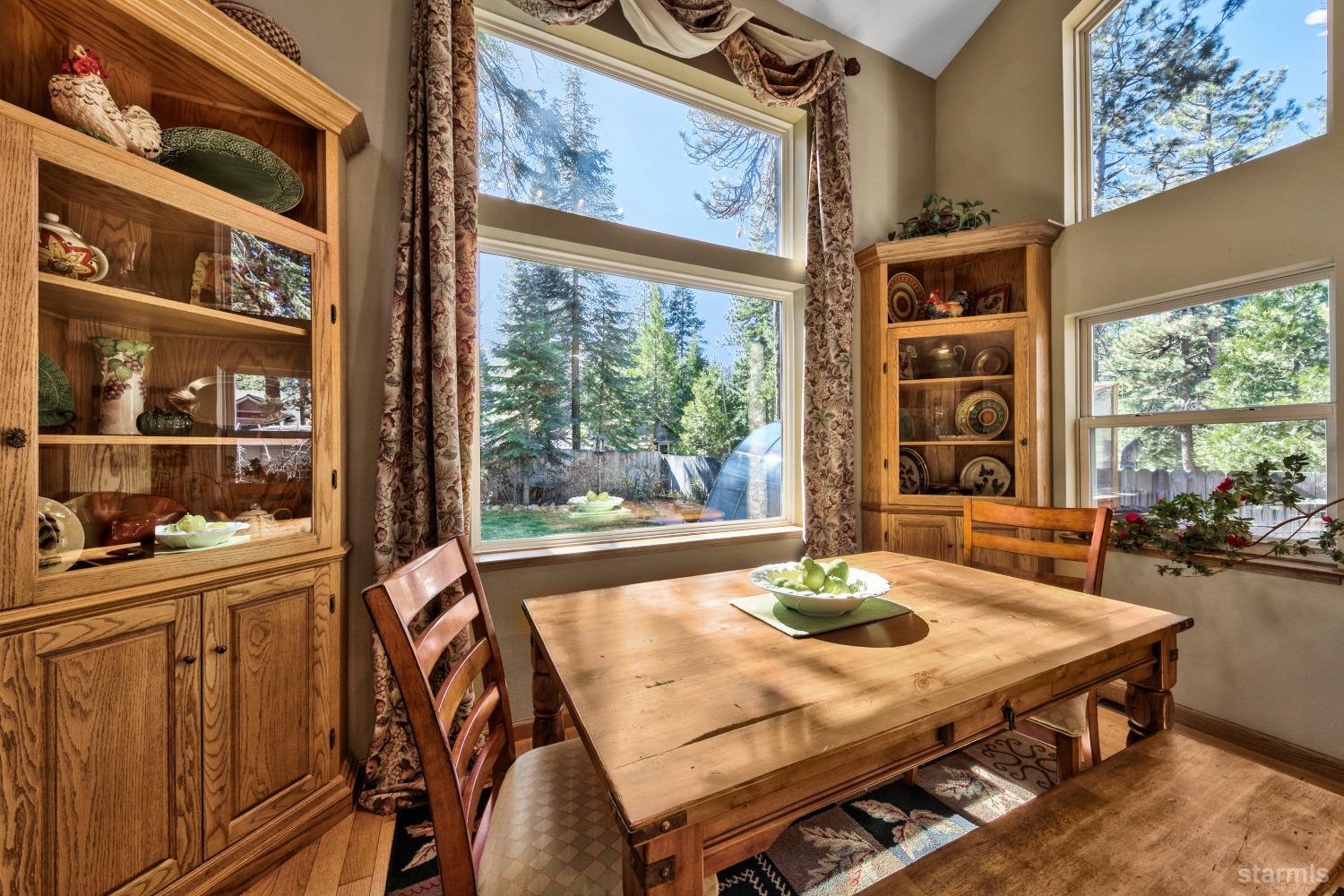 712 Sand Harbor Road South Lake Tahoe, CA 96150 - Photo 17 of 38 a dining room with furniture a rug and a large window
