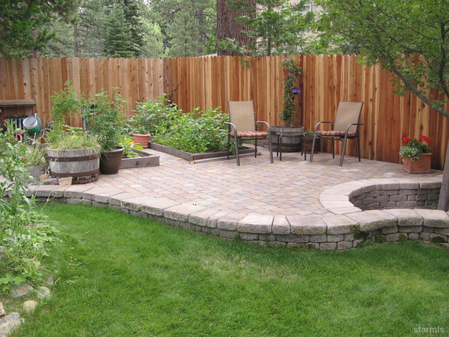 712 Sand Harbor Road South Lake Tahoe, CA 96150 - Photo 25 of 38 a view of a backyard with lawn chairs potted plants and wooden fence