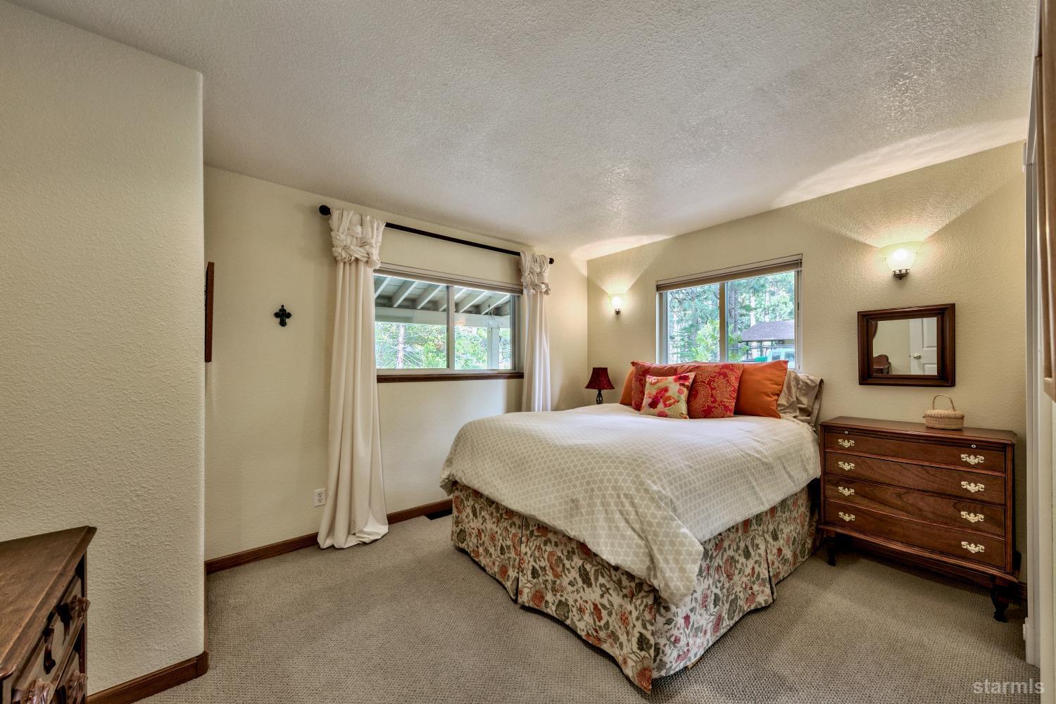 712 Sand Harbor Road South Lake Tahoe, CA 96150 - Photo 32 of 38 a bedroom with a bed a mirror and windows