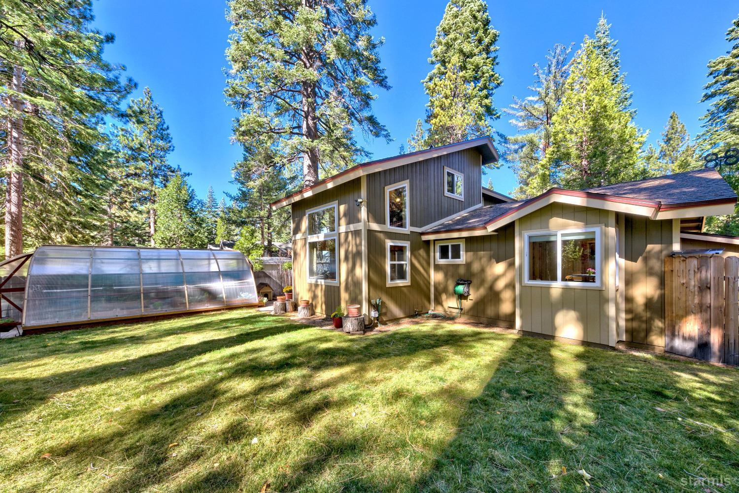 712 Sand Harbor Road South Lake Tahoe, CA 96150 - Photo 5 of 38 a front view of a house with a yard table and chairs