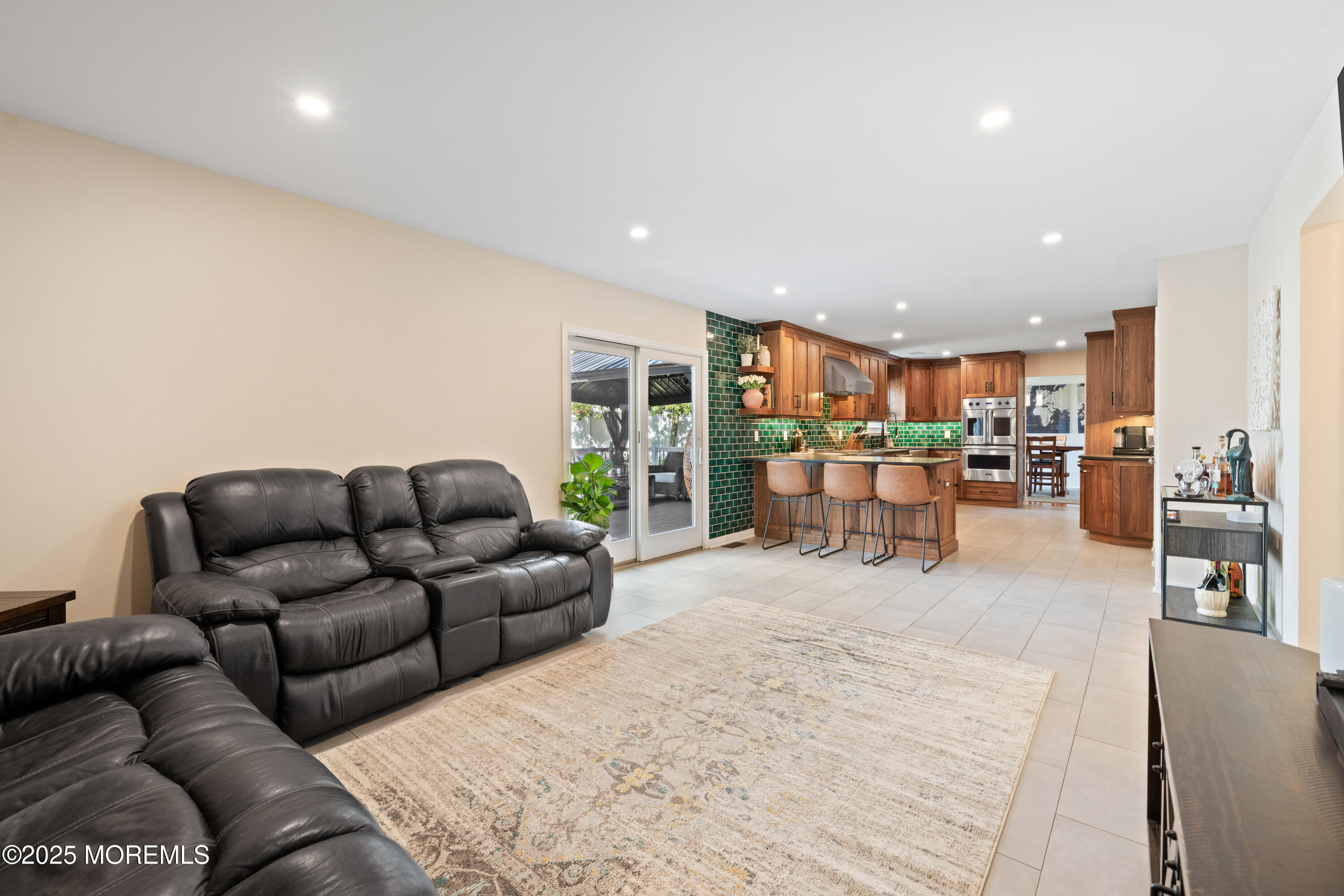 832 Constitution Drive Brick, NJ 08724 - Photo 12 of 24 a living room with furniture and a kitchen view