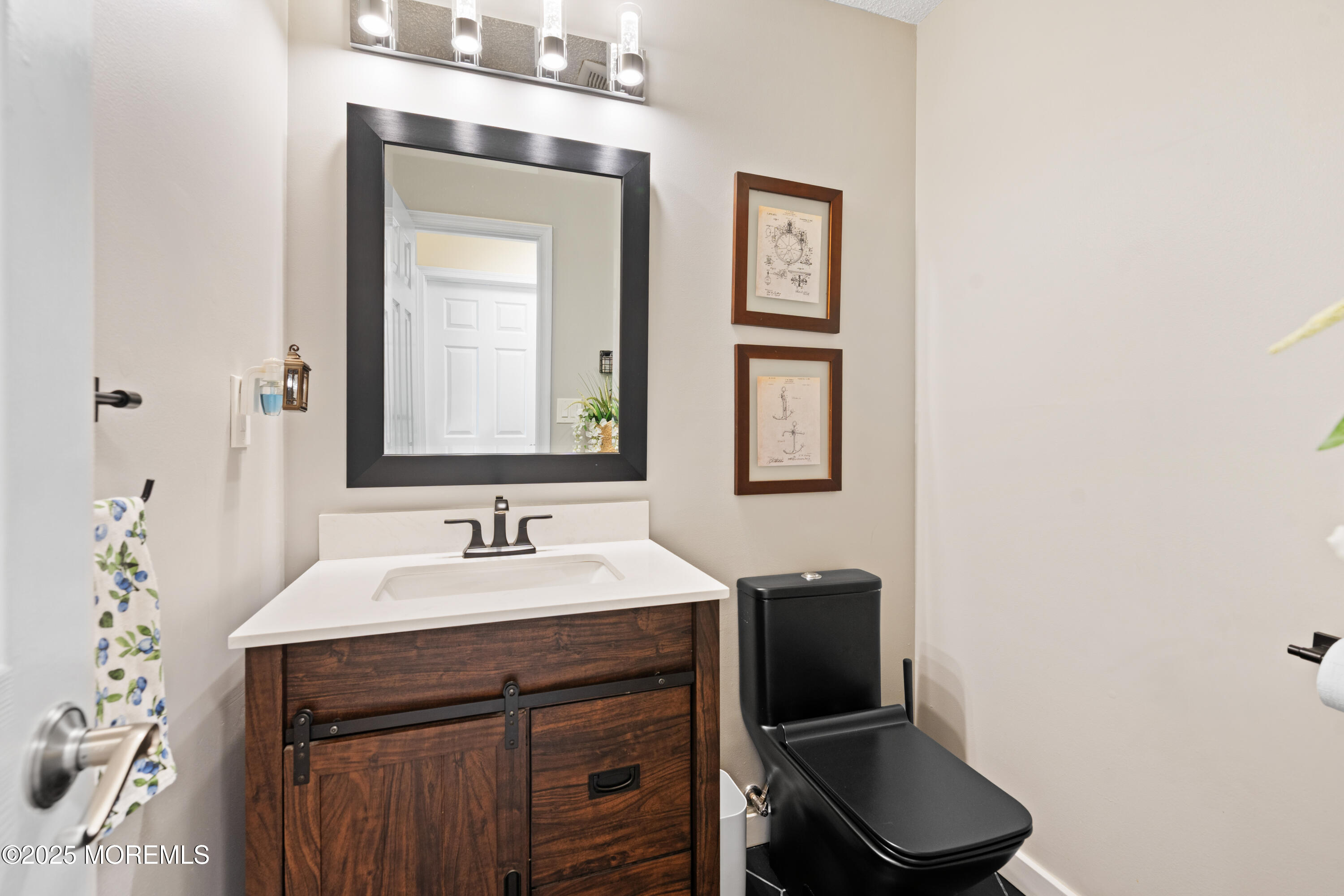 832 Constitution Drive Brick, NJ 08724 - Photo 13 of 24 a bathroom with a toilet sink and mirror