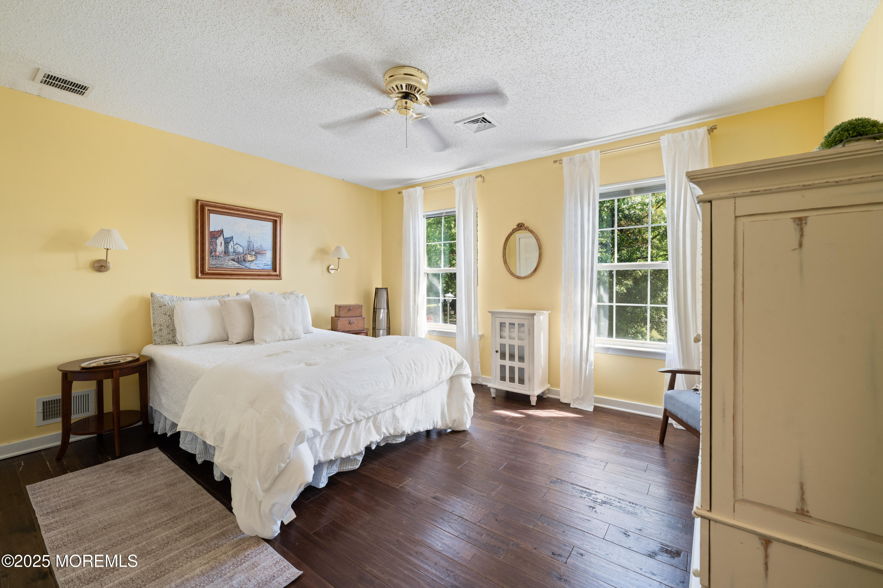 832 Constitution Drive Brick, NJ 08724 - Photo 17 of 24 a spacious bedroom with a large bed chandelier and a window