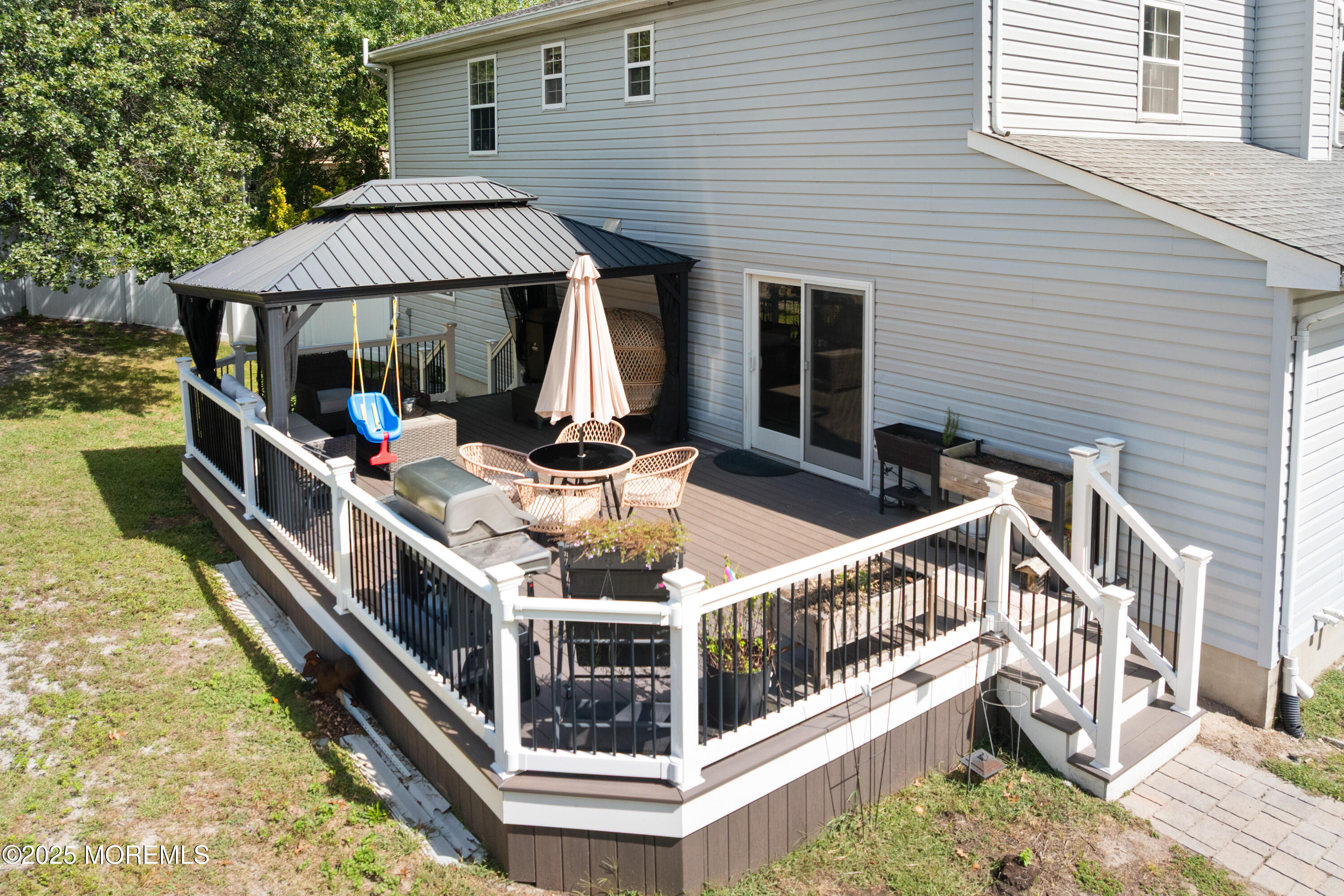 832 Constitution Drive Brick, NJ 08724 - Photo 23 of 24 a balcony with furniture and a potted plant