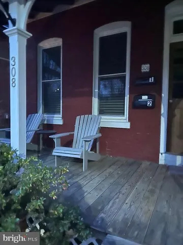 a view of a wooden bench sitting in front of a building