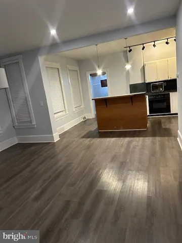 a view of a room with kitchen countertops and a ceiling fan