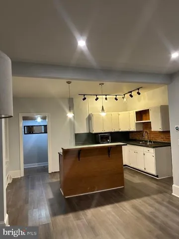 a kitchen with granite countertop a stove and a sink