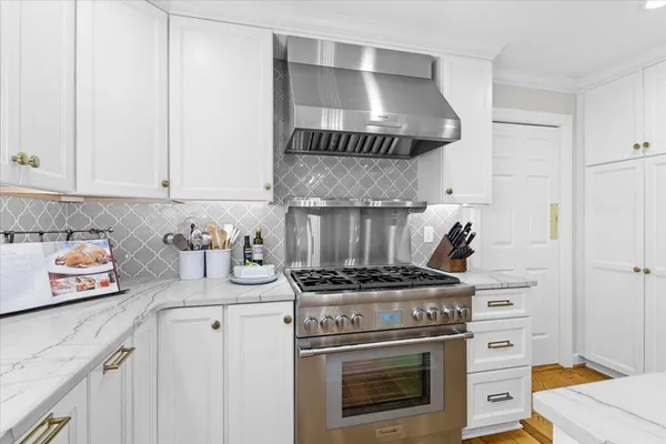 a kitchen with stainless steel appliances granite countertop a refrigerator a stove and a sink with granite countertops