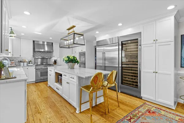 a stove top oven sitting inside of a kitchen
