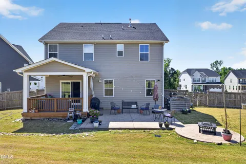a view of a house with swimming pool next to a yard