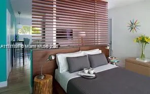a bed sitting in a bedroom next to a window