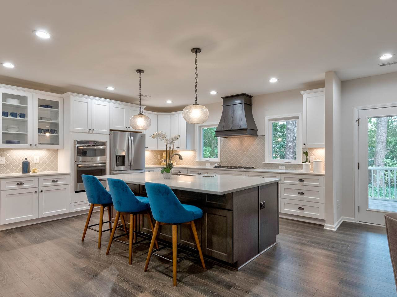 1000 Deerfield Road Raleigh, NC 27609 - Photo 10 of 30 An abundance of white cabinetry with quartz counters. Glass front cabinet for displaying dishes. Under cabinet lighting. Kitchen