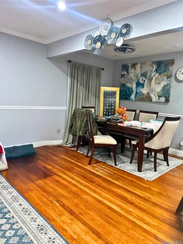 a living room with patio furniture and a wooden floor