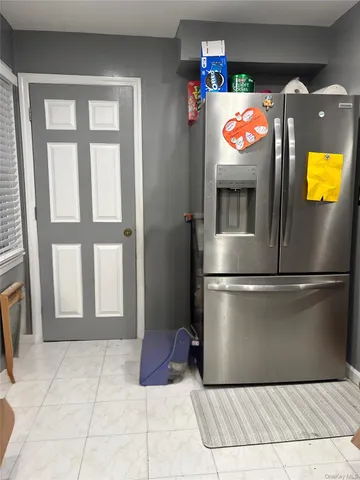 a kitchen with a refrigerator and a stove top oven