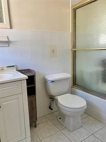 a white toilet sitting next to a bathroom sink