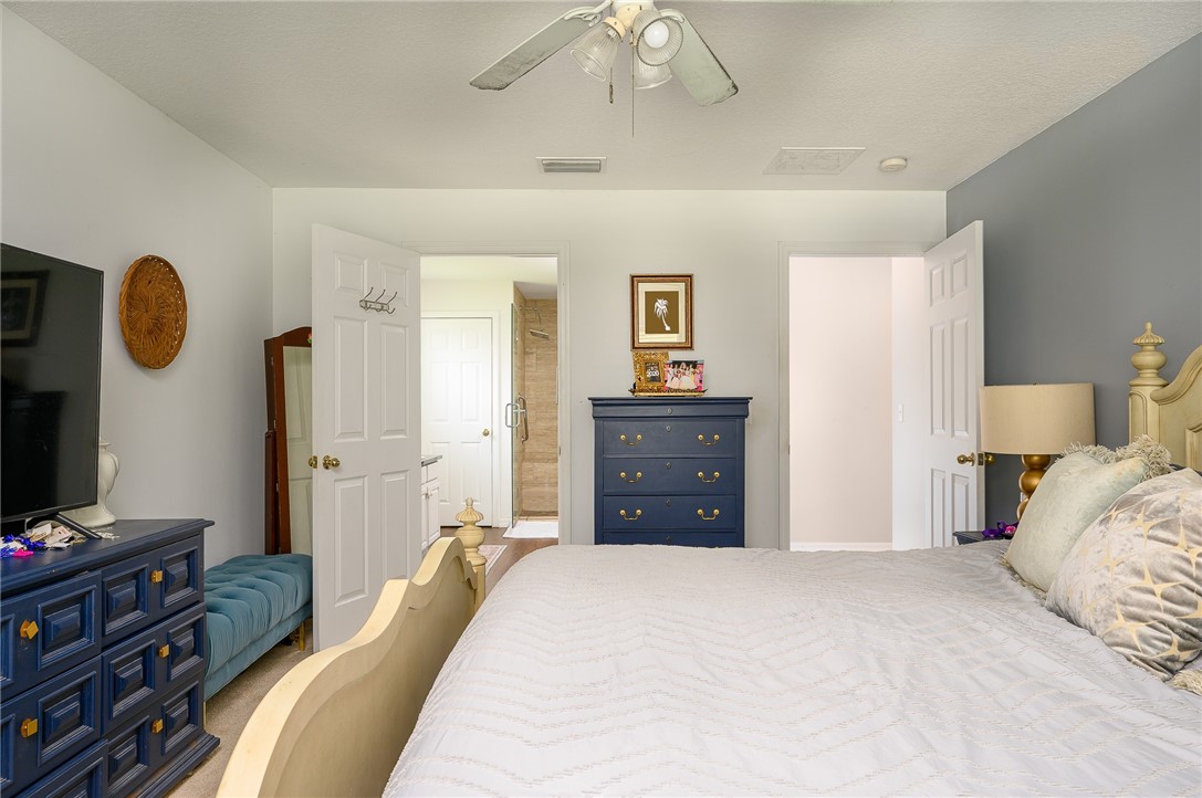 114 Drake Way Sebastian, FL 32958 - Photo 11 of 34 a bedroom with a bed and a chandelier