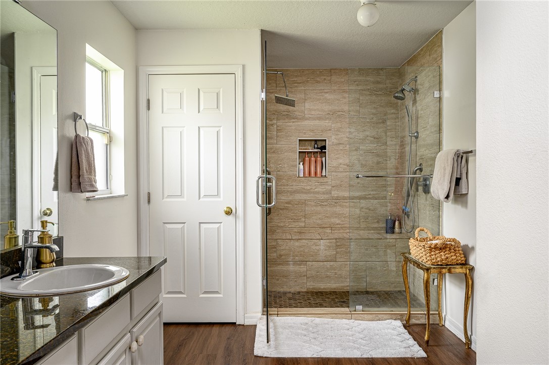 114 Drake Way Sebastian, FL 32958 - Photo 12 of 34 a bathroom with a granite countertop shower a sink and a mirror