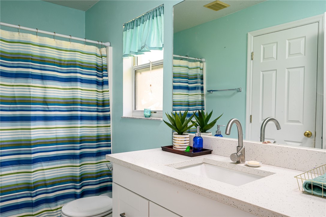 114 Drake Way Sebastian, FL 32958 - Photo 16 of 34 a bathroom with a sink a mirror and shower