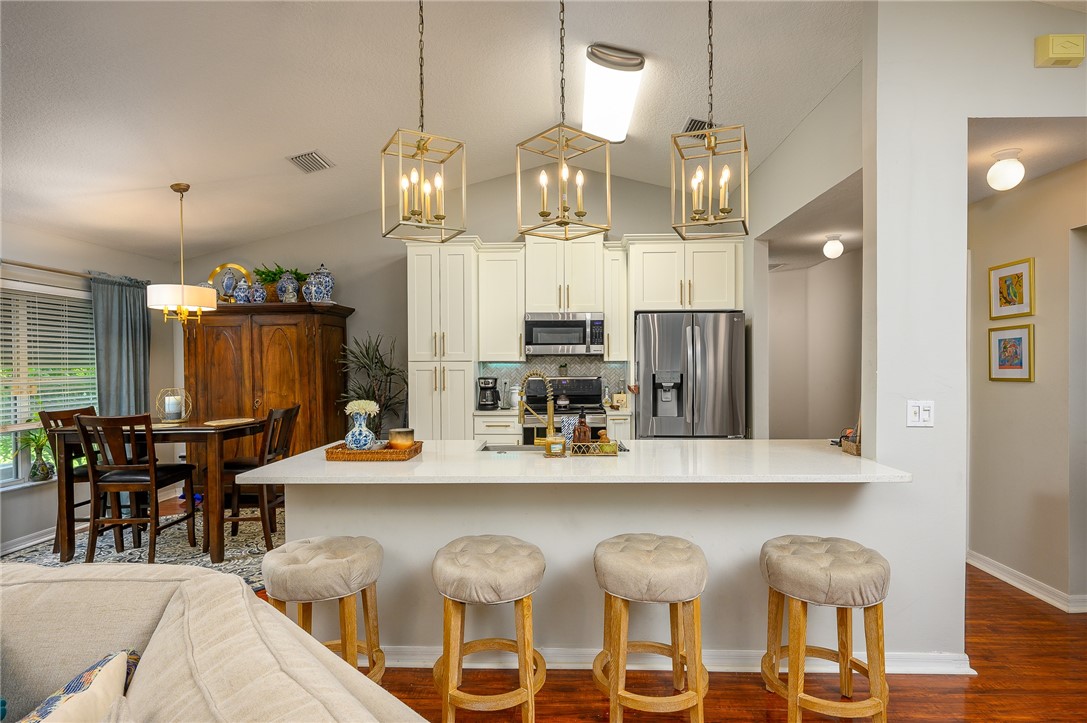114 Drake Way Sebastian, FL 32958 - Photo 2 of 34 a kitchen with a dining table chairs and wooden floor