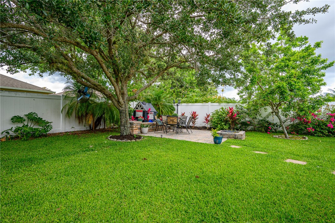 114 Drake Way Sebastian, FL 32958 - Photo 25 of 34 a view of a backyard with a garden and trees