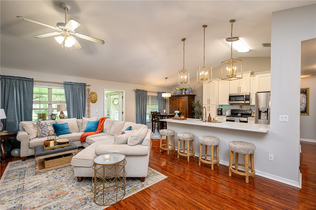 114 Drake Way Sebastian, FL 32958 - Photo 3 of 34 a living room with furniture kitchen view and a chandelier