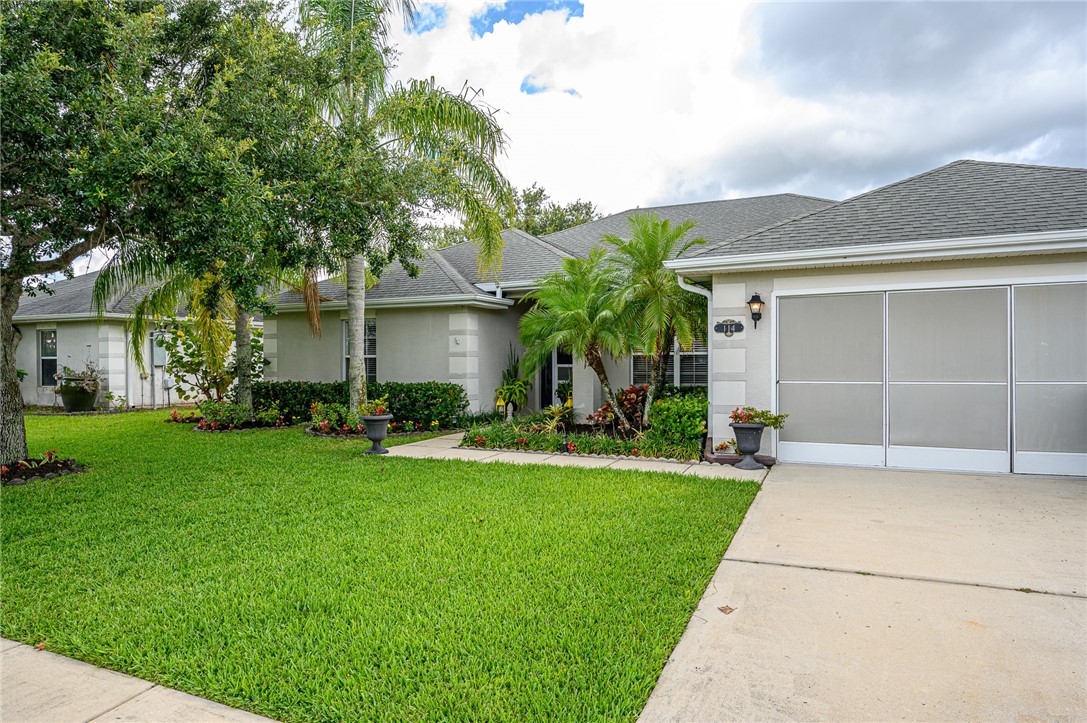 114 Drake Way Sebastian, FL 32958 - Photo 32 of 34 a front view of a house with a yard and garage