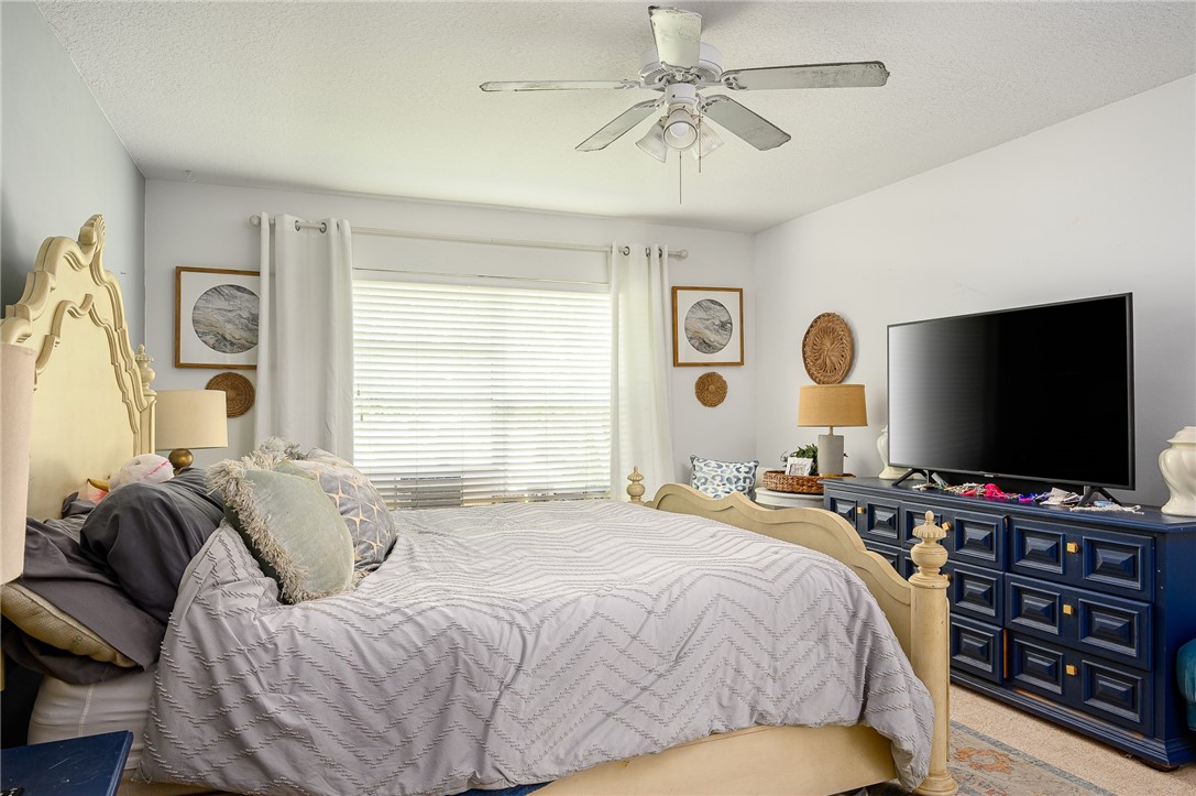 114 Drake Way Sebastian, FL 32958 - Photo 10 of 34 a bedroom with a bed and a flat screen tv