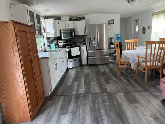 a bathroom with a sink and mirror with toilet