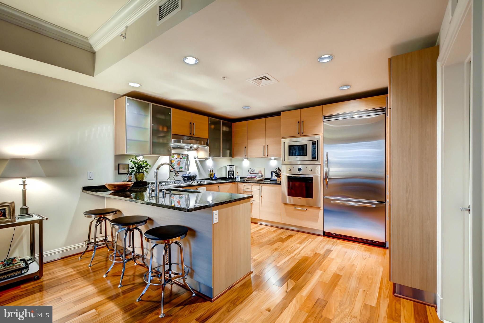 801 Key Highway, Unit 122 Baltimore, MD 21230 - Photo 12 of 30 a kitchen with stainless steel appliances granite countertop a refrigerator and a stove top oven