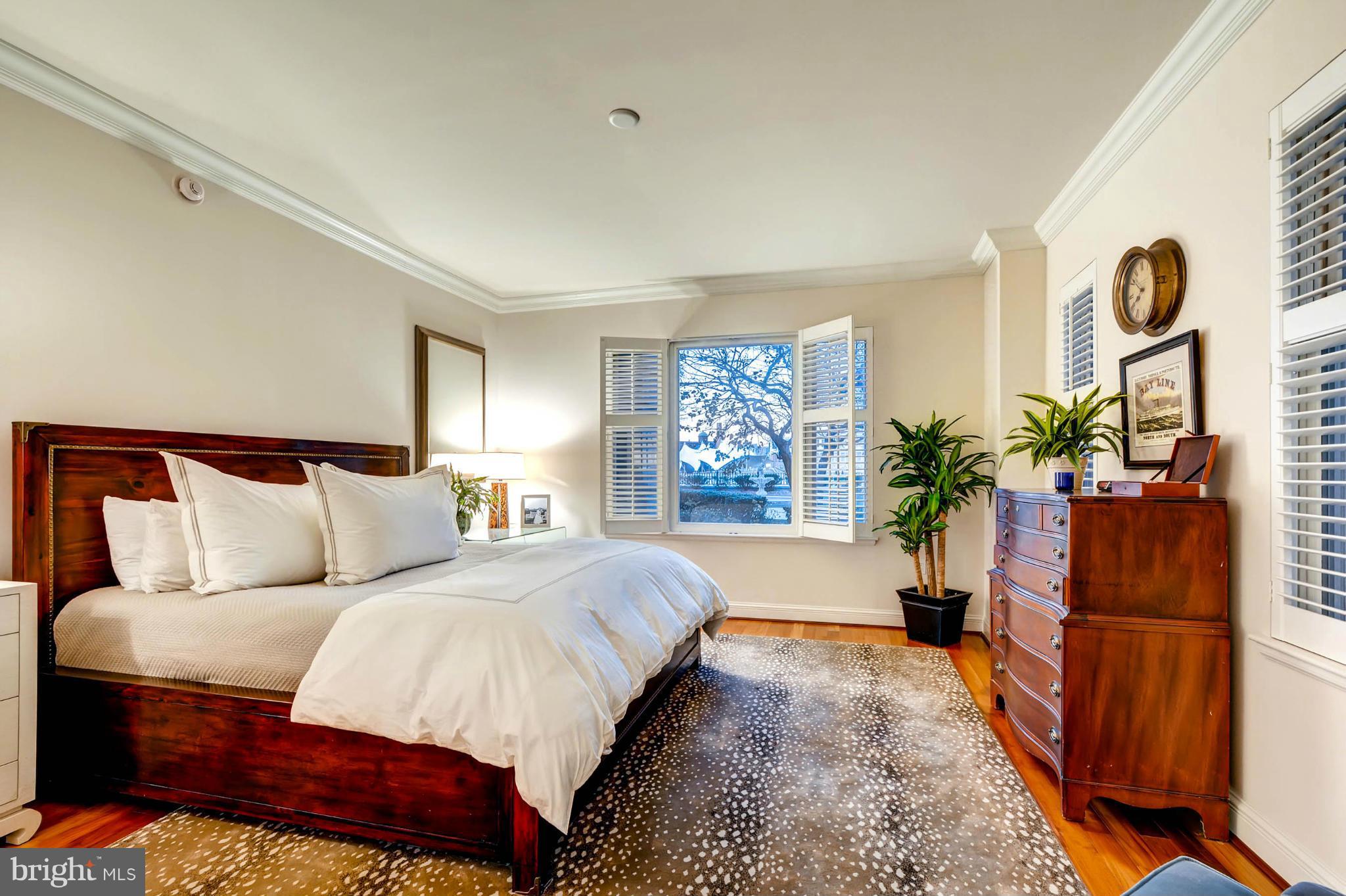 801 Key Highway, Unit 122 Baltimore, MD 21230 - Photo 15 of 30 a bed room with a bed and a potted plant