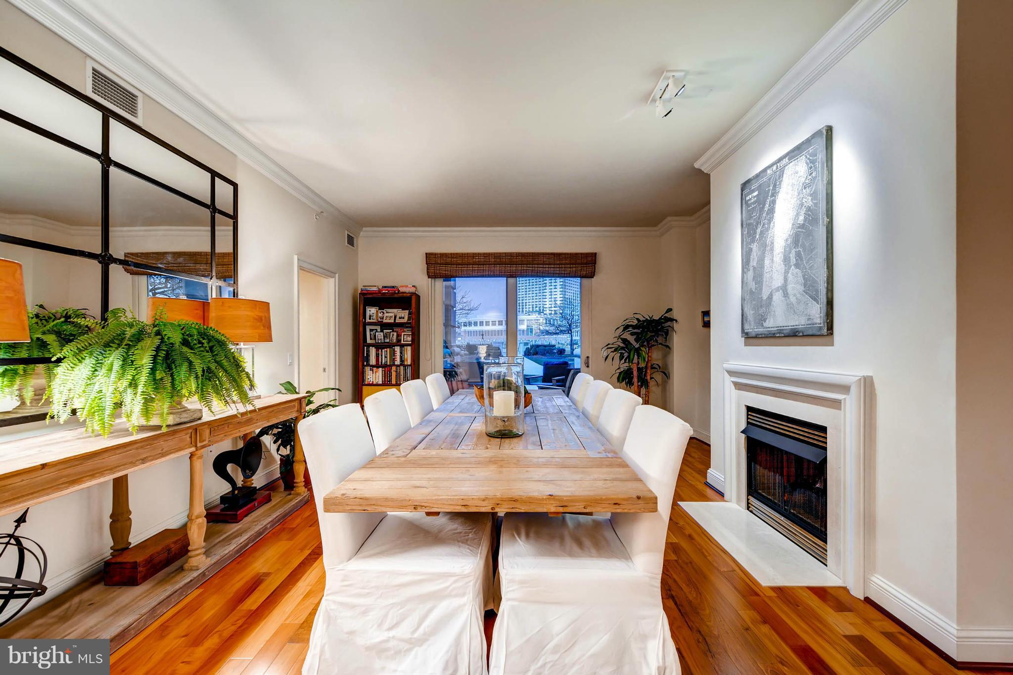 801 Key Highway, Unit 122 Baltimore, MD 21230 - Photo 7 of 30 a dining room with furniture a fireplace and wooden floor