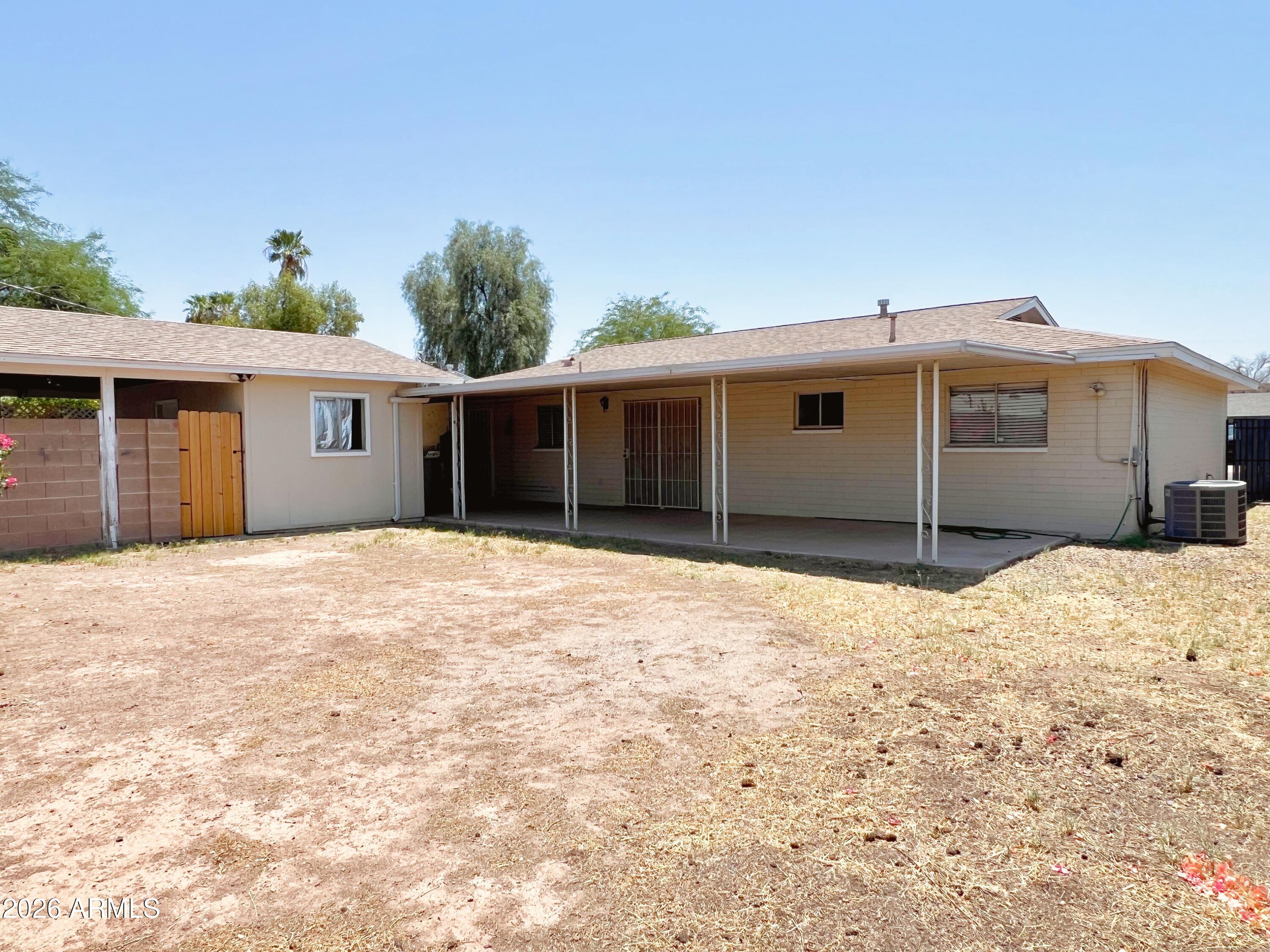 1220 West Romo Jones Street Tempe, AZ 85281 - Photo 25 of 26 a view of a house with a yard