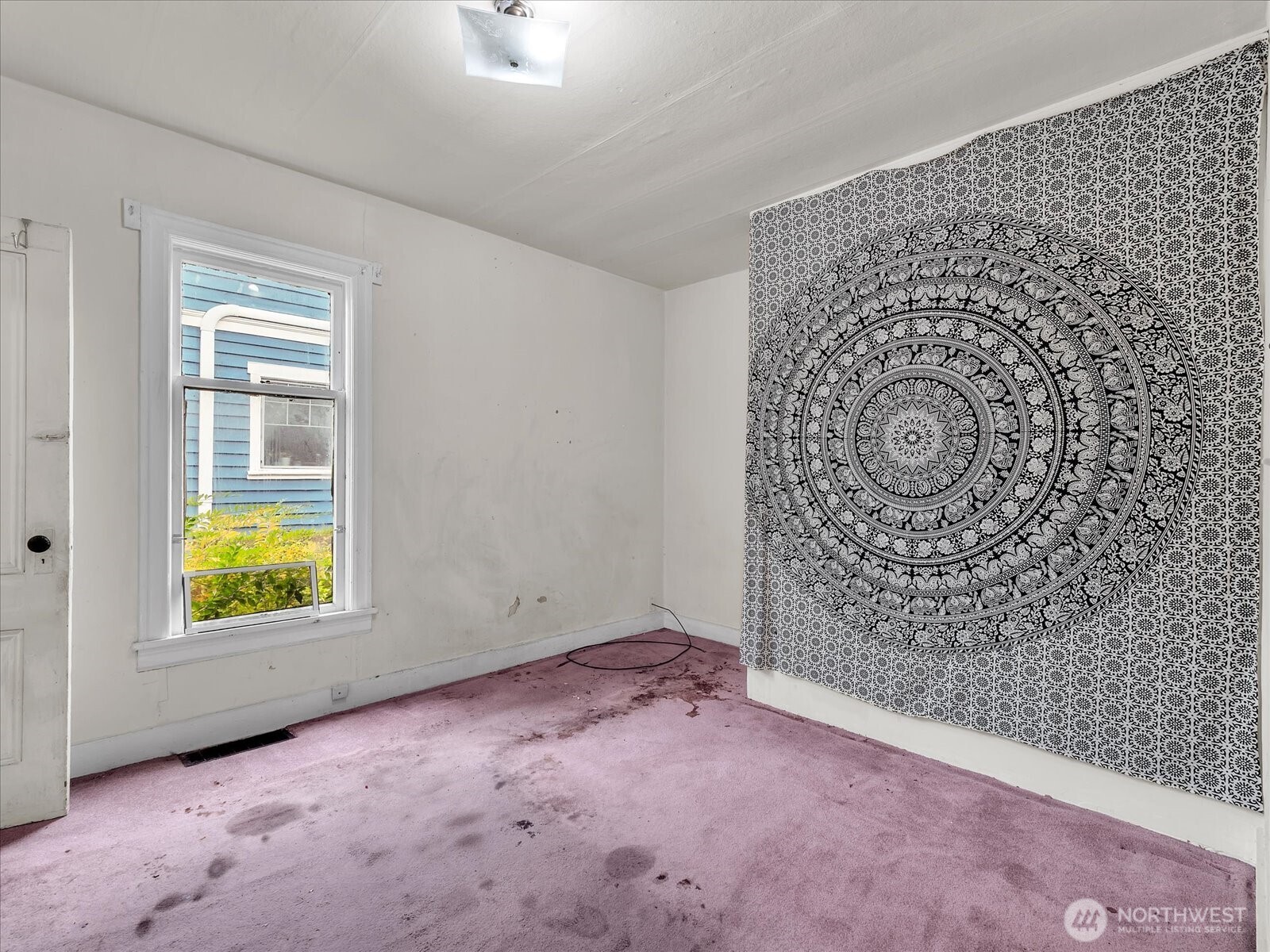 203 23rd Avenue Seattle, WA 98122 - Photo 9 of 26 an empty room with windows