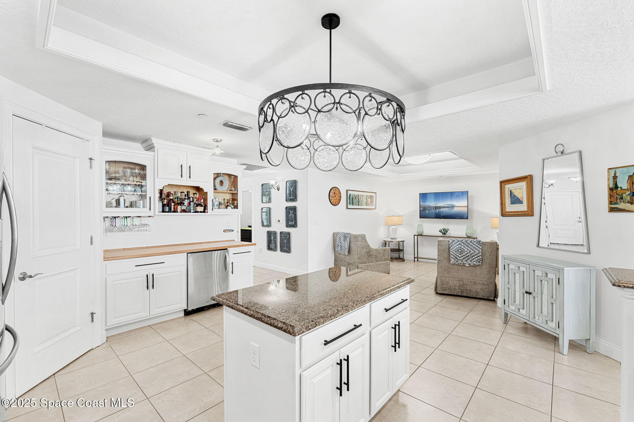 505 South Miramar Avenue, Unit 2403 Indialantic, FL 32903 - Photo 20 of 43 a kitchen with granite countertop cabinets a stove a dining table and chairs