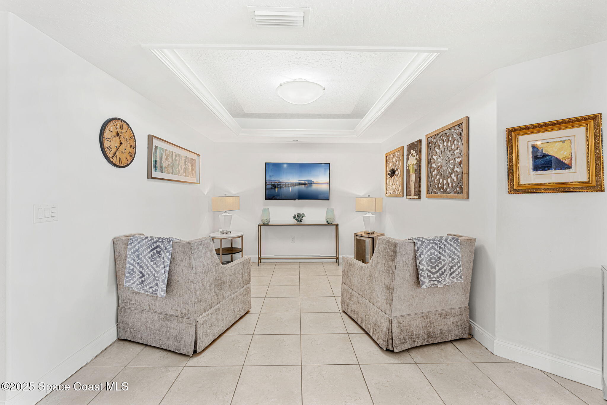 505 South Miramar Avenue, Unit 2403 Indialantic, FL 32903 - Photo 21 of 43 a living room with furniture and a flat screen tv