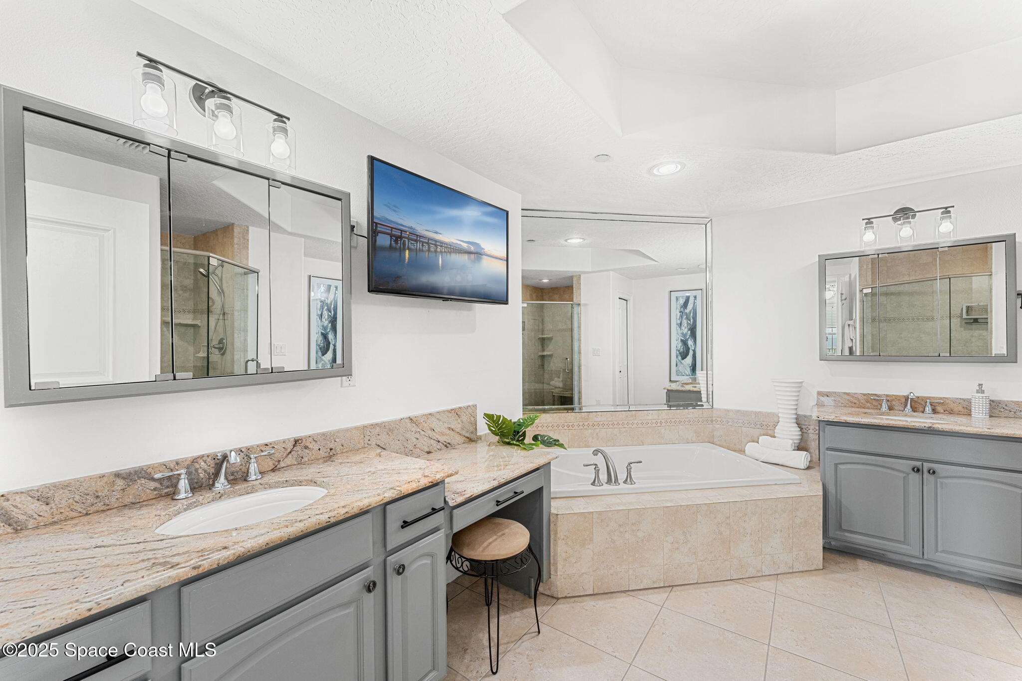 505 South Miramar Avenue, Unit 2403 Indialantic, FL 32903 - Photo 24 of 43 a bathroom with a granite countertop tub sink and mirror